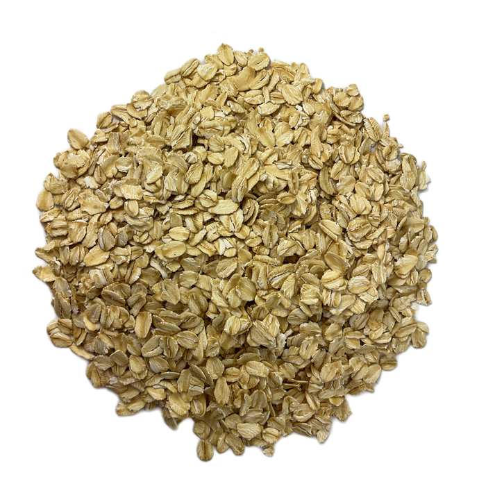 Circular pile of Flaked Oats, otherwise known as Rolled Oats, intended for brewing homemade beer.