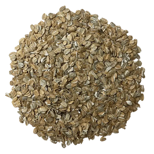 Flaked Rye grain for brewing arranged in a circle, to show off the grains consistency and color.