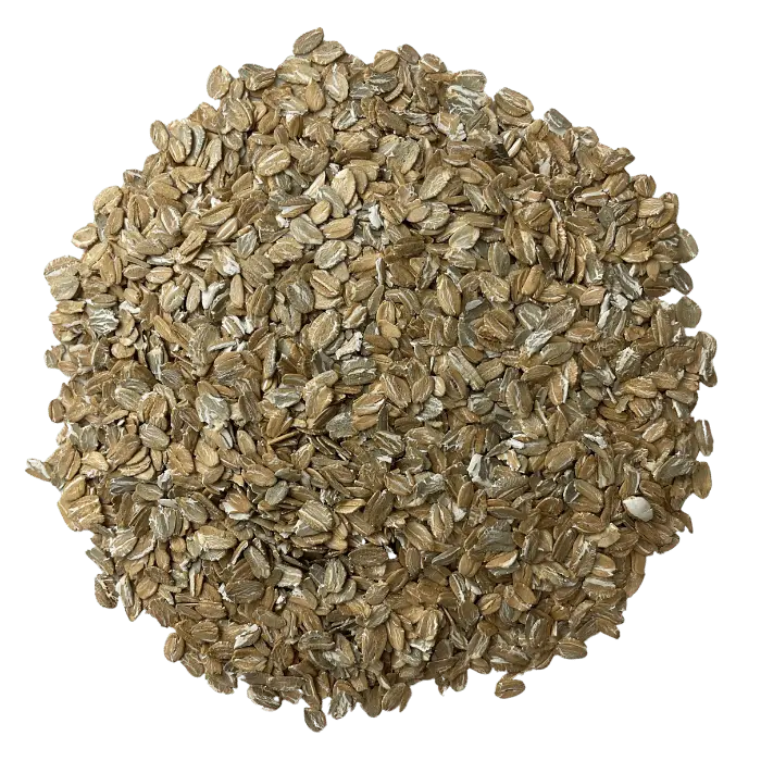 Flaked Rye grain for brewing arranged in a circle, to show off the grains consistency and color.