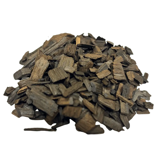 A pile of heavy toasted French White Oak chips used for flavoring wine and mead, angled view.